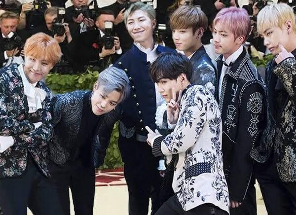 What outfits have the members worn that would fit right in at the Met Gala?