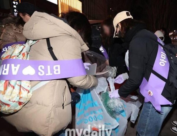 ARMYS staying behind to clean after concert