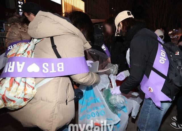 ARMYS staying behind to clean after concert